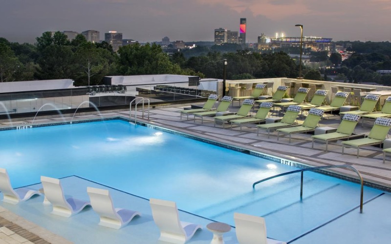 a swimming pool with chairs around it