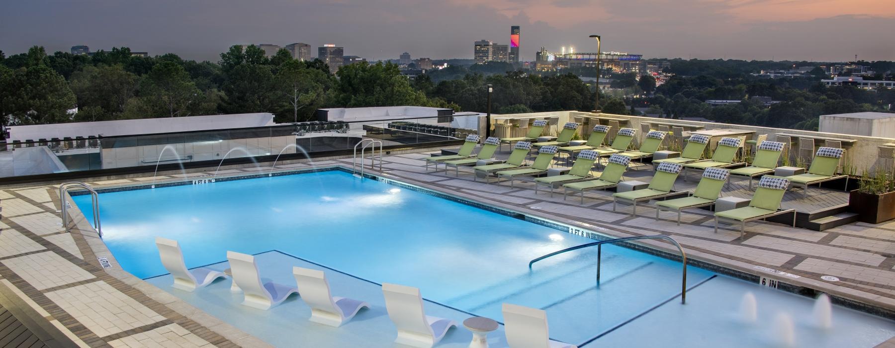 a swimming pool with chairs around it
