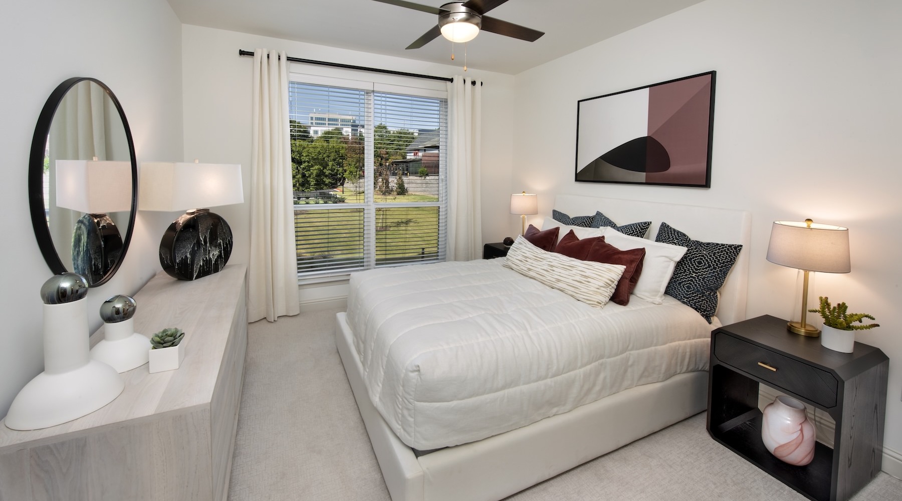 Generous bedroom offerings to fit every family a bedroom with a nightstand, dresser and a window