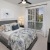 a bedroom with a large bed and a large window