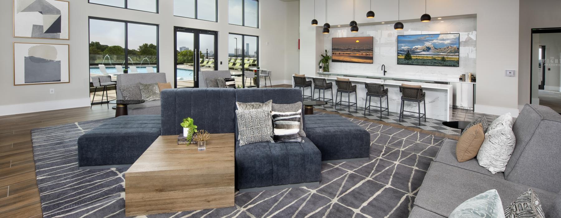 a living room with a large rug and a large window
